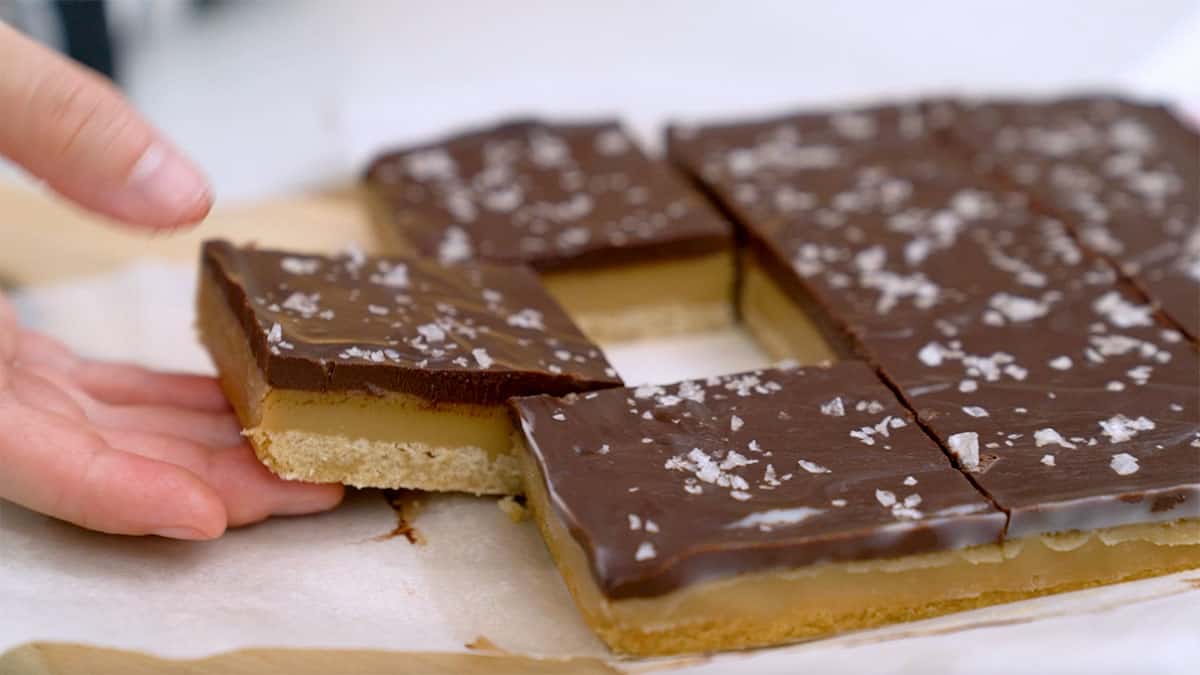 slices of vegan millionaire shortbread on a cutting board