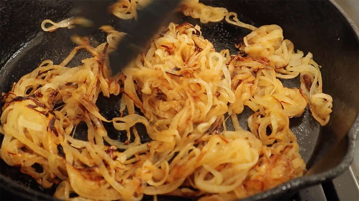 a skillet with onions in it being caramelized