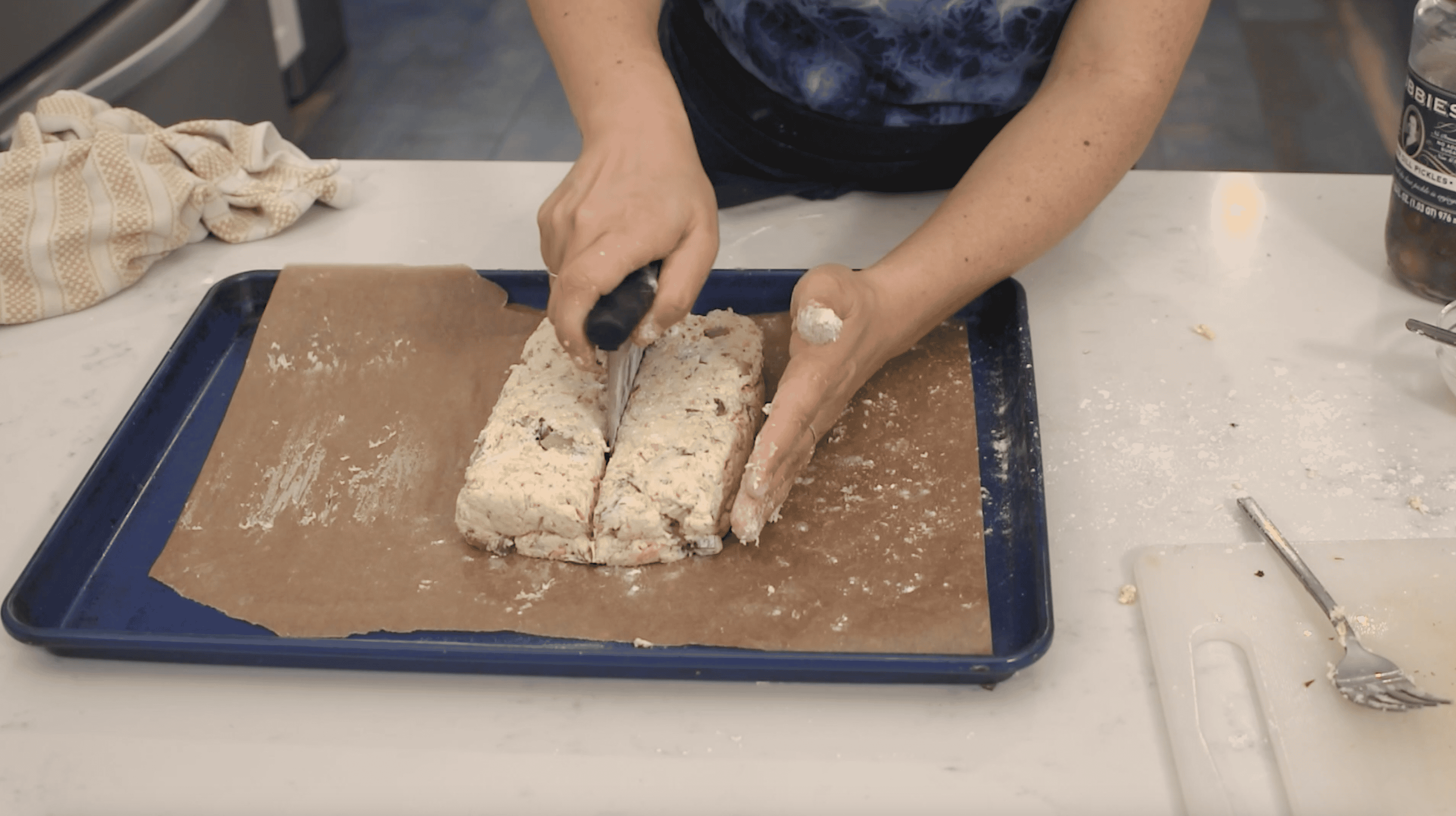dough being cut into biscuits with a dough cutter