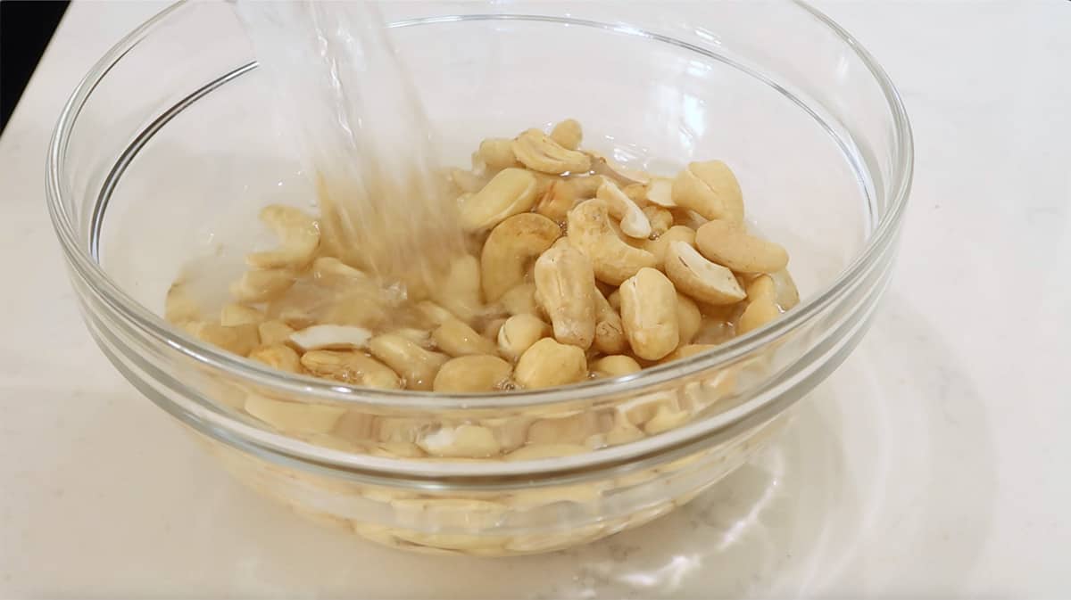 bowl of raw cashews with water