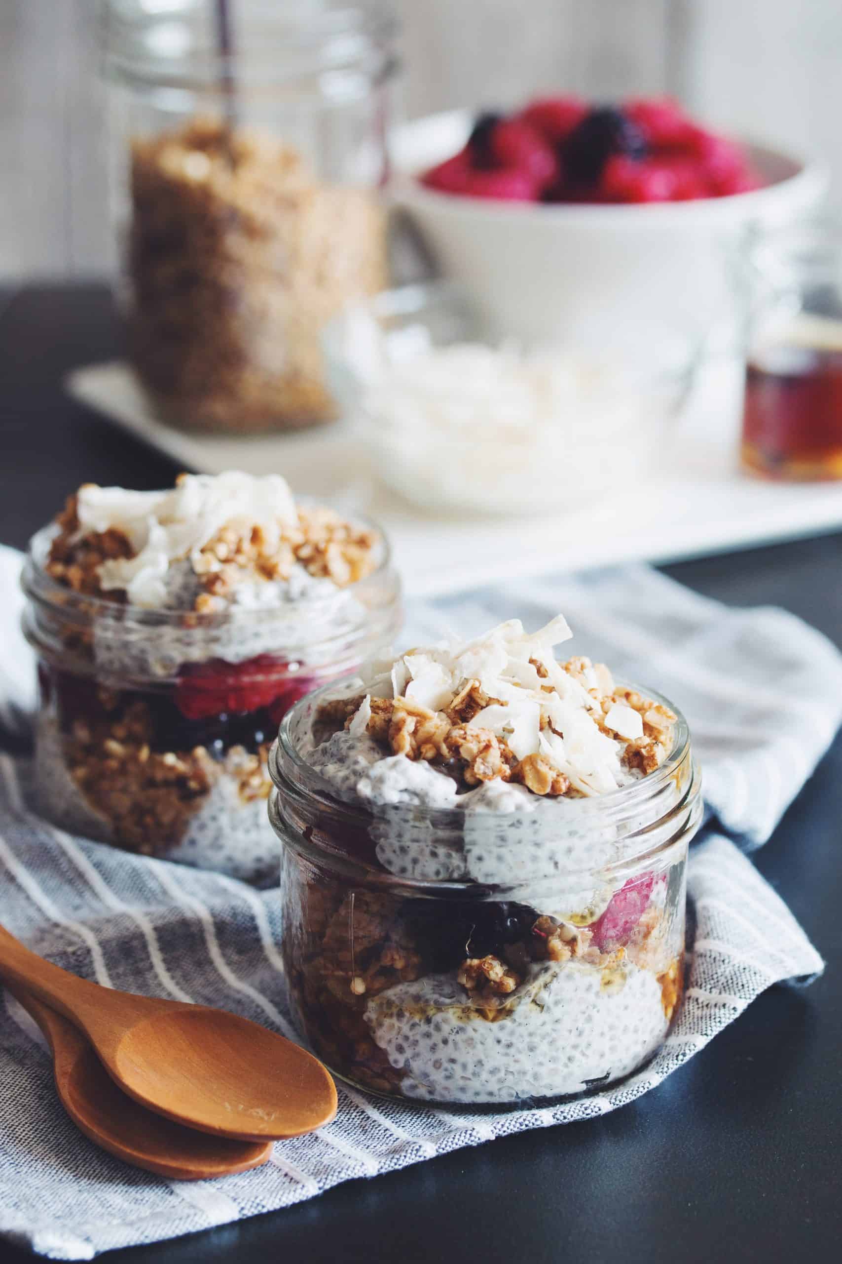 side view of two jars of coconut milk and chia seed pudding parfaits