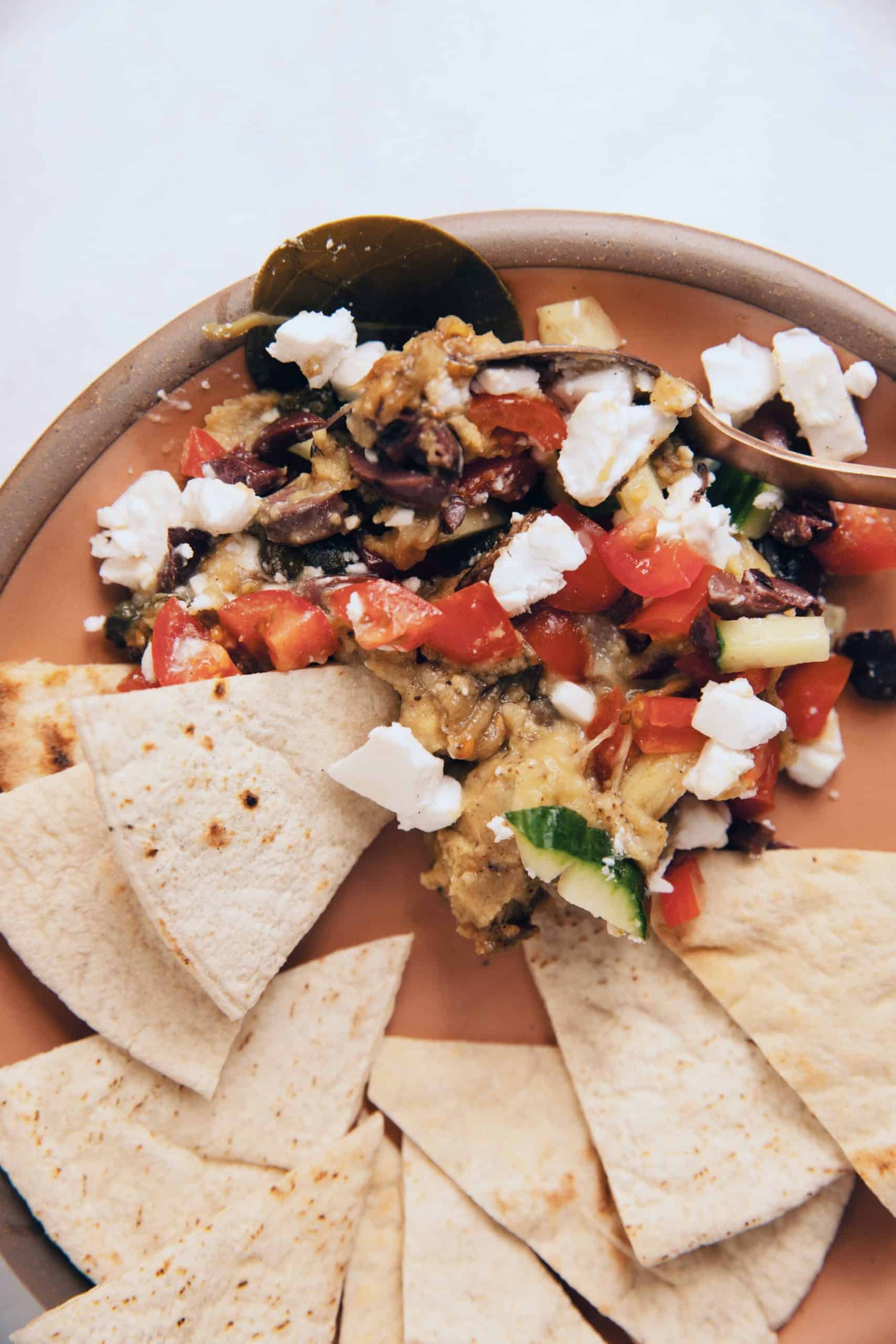 vegan 7 layer Greek dip with fava, eggplant, vegan feta and olives