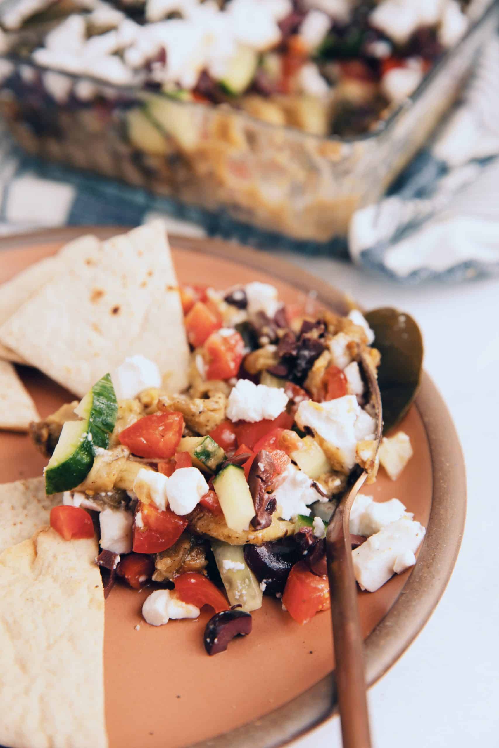 vegan 7 layer Greek dip with fava, eggplant, vegan feta and olives