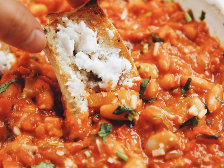 cheesy harissa beans served with toasted sourdough and vegan cheese