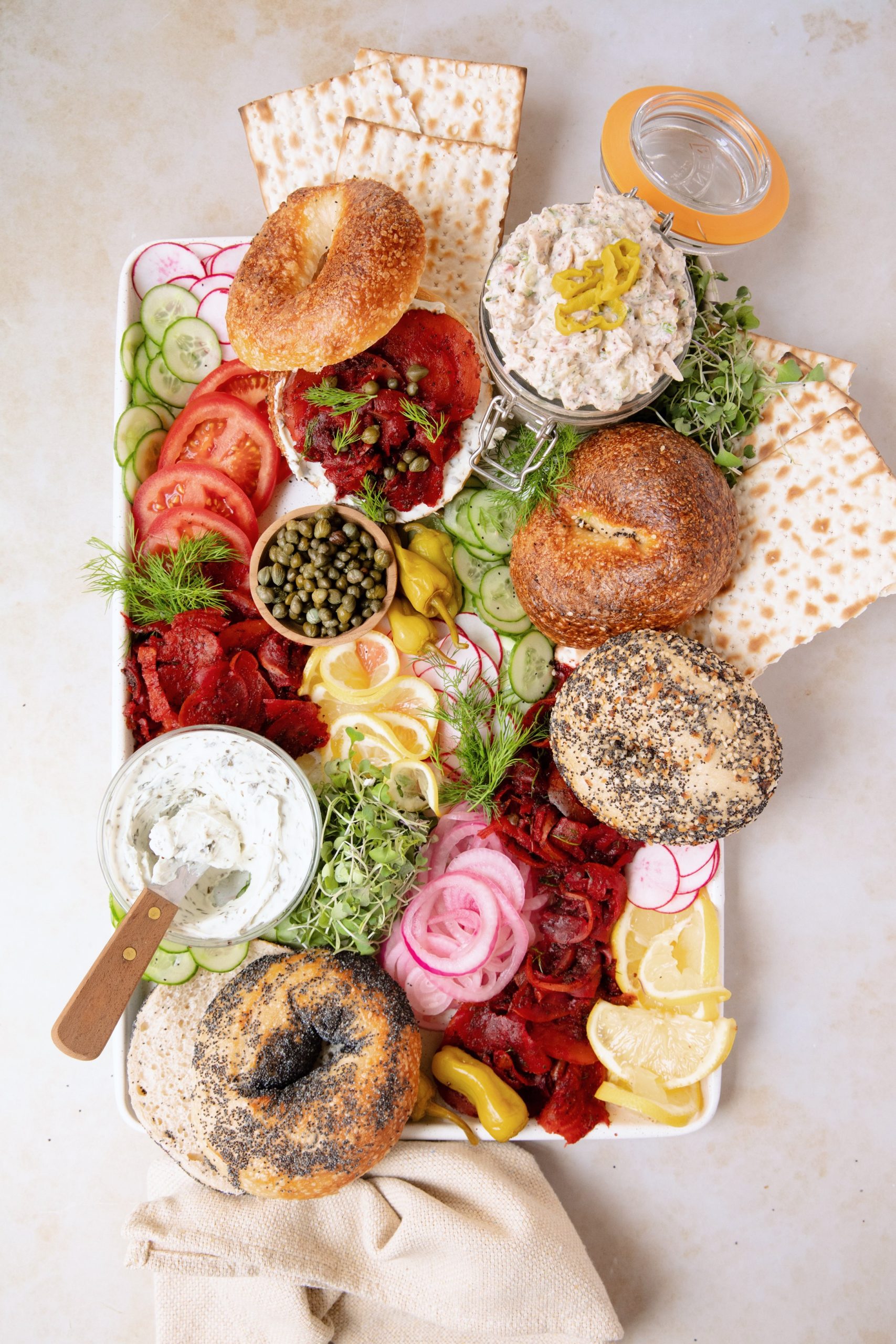 plant-based deli-style bagel board with pickled onions and capers