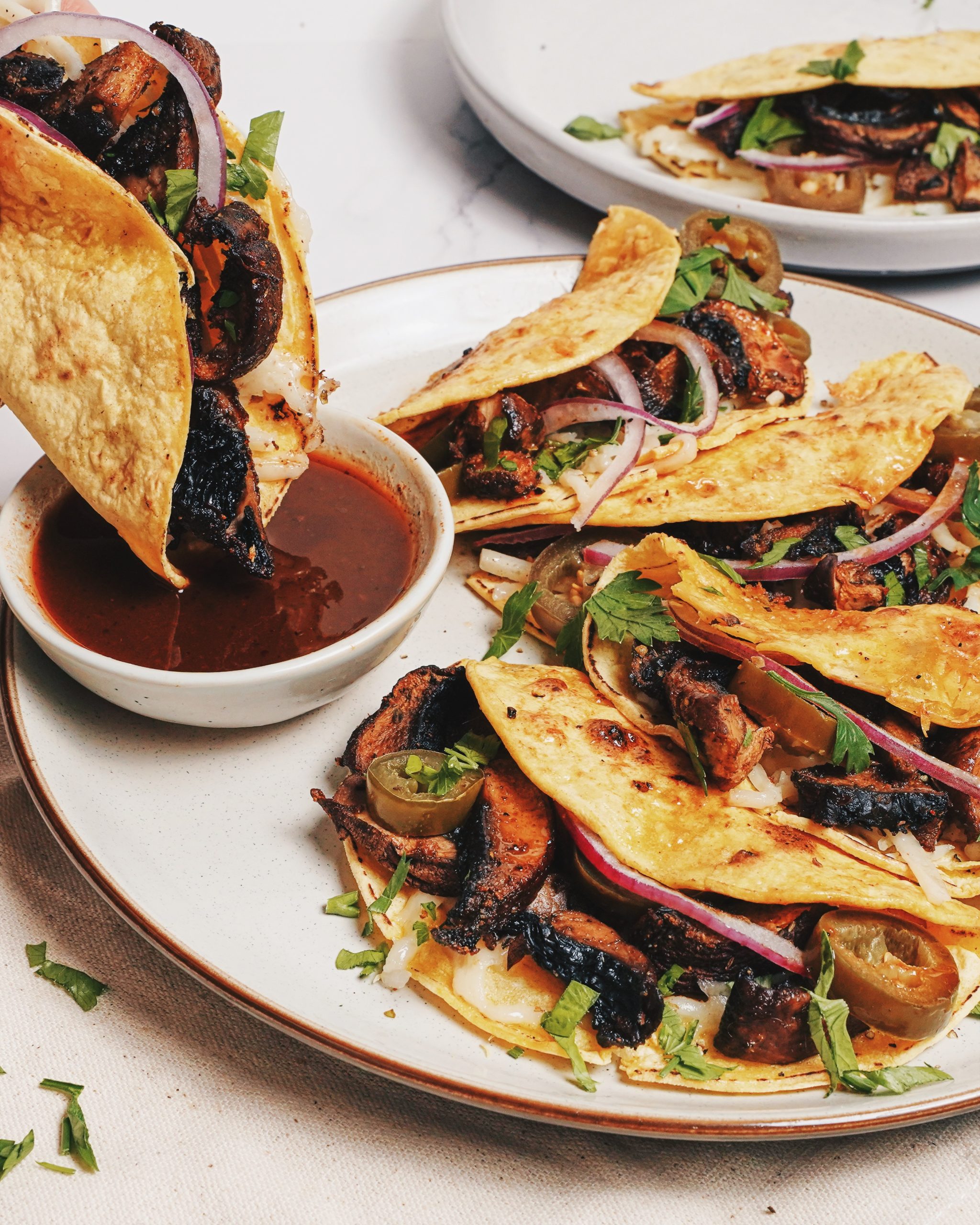 sheet pan mushroom birria tacos with crispy tortillas and consommé dipping broth