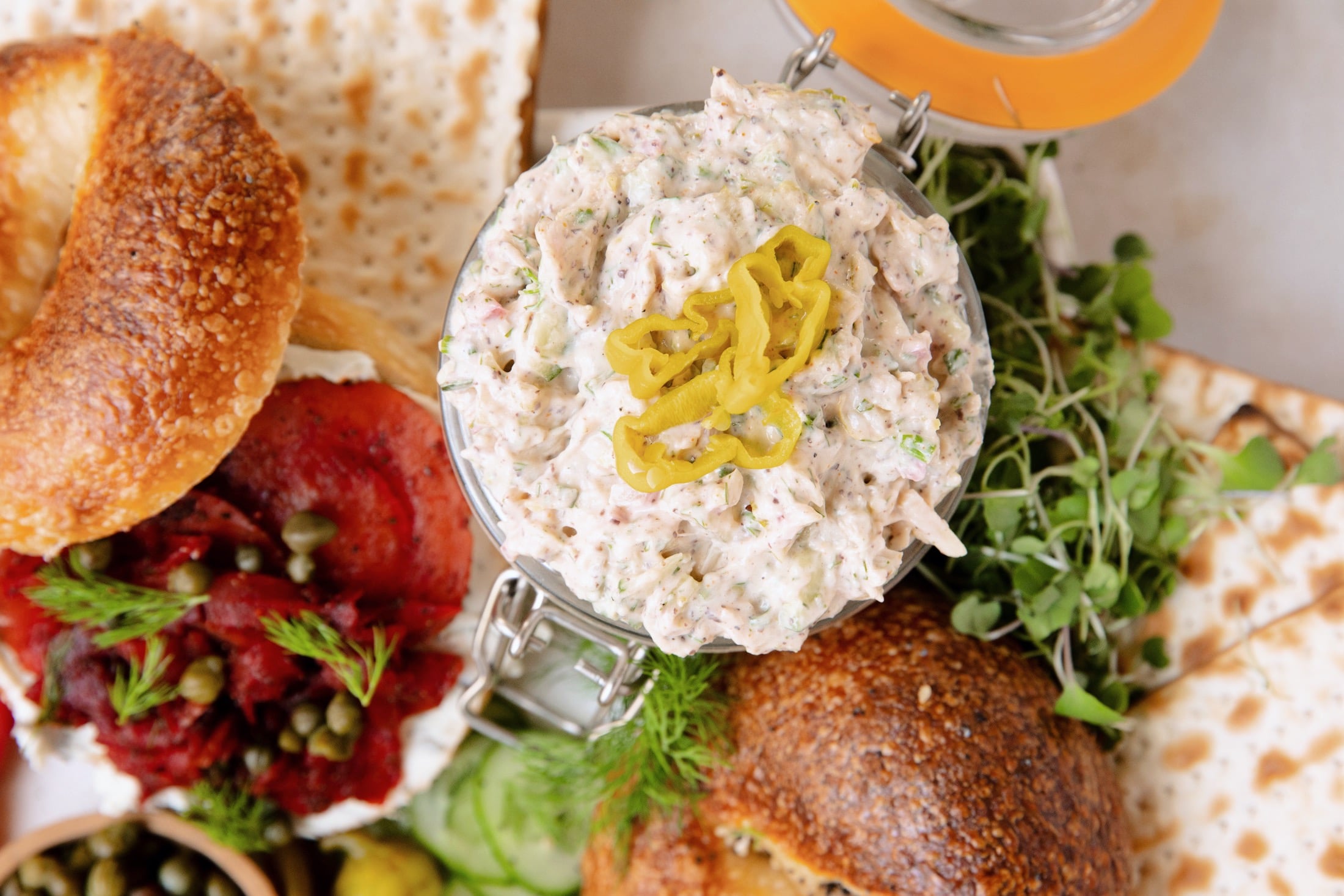 close up of vegan white dish spread on a bagel board